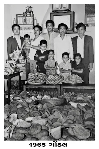 The supplied 1965 Gondal family photograph behind a counter filled with sweets
